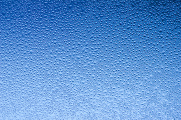 Macro abstract background design of window condensation in blue hues