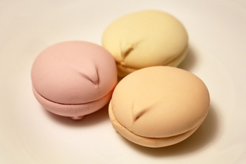 Colorful marshmallow cakes on white plate. New Year sweets, holiday dessert