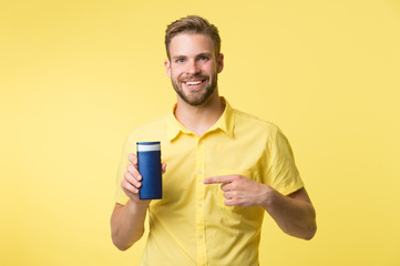 Best shampoo for your hair type. Make hair stronger and more resilient. Man handsome bearded hipster hold plastic bottle shampoo or shower gel. Hair care concept. Effective shampoo. Try this shampoo