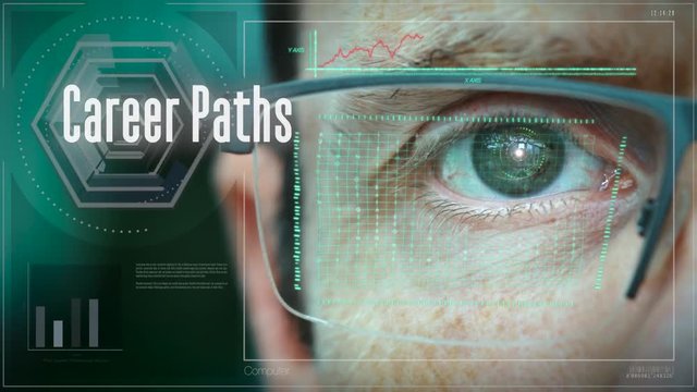 A close up of a businessman eye controlling a futuristic computer system with a Career Paths concept.