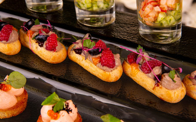 Brusketa with a guinea fowl, berries, greens, red caviar, mousse, raspberry, blackberry