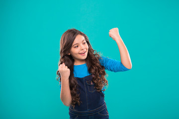 Achieve success. Kid cheerful celebrate victory. Girl cute child long curly hair happy smiling. Child psychology and development. Happy winner. Celebrate victory or achievement. Successful happy kid