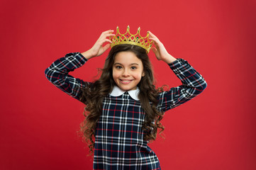 Princess manners. Elegancy suit her. Kid wear golden crown symbol of princess. Every girl dreaming to become princess. Lady little princess. Girl wear crown red background. Monarch family concept