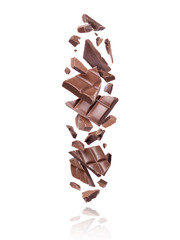 Broken bars of dark chocolate fall down on white background