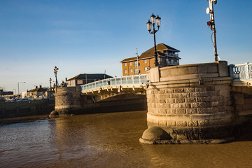 Fototapeta premium Road bridge over the river in a bright and sunny day