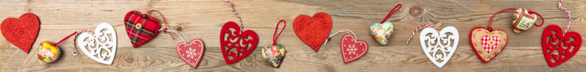 Valentines day. Top view, flat lay of various hearts, wooden background, banner.