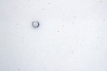 Bottle cap lying in the snow in the winter
