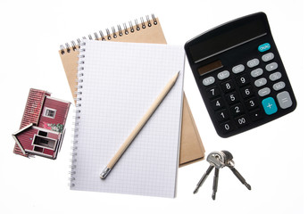 Notebook calculator small house keys on white background isolation, top view