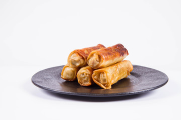 Chinese Traditional Spring rolls on a black plate