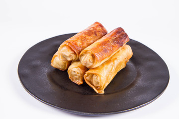Chinese Traditional Spring rolls on a black plate