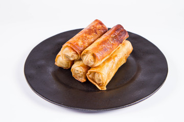 Chinese Traditional Spring rolls on a black plate