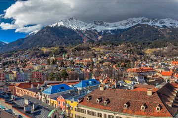Naklejka na ściany i meble People in Innsbruck city center under Stadtturm tower. It is capital city of Tyrol in western Austria, Europe.
