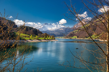 Fototapeta na wymiar Lungernersee with Swiss Alps. Lungernersee is a natural lake in Obwalden, Switzerland, Europe