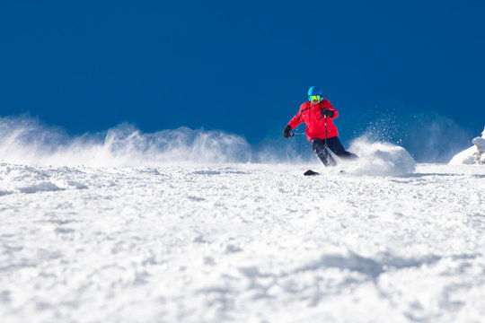 Man skiing on the prepared slope with fresh new powder snow