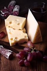 fuet spanish cheese and grape on wooden board