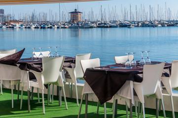 Served  tables at yachting club beach restaurant