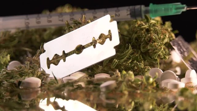 Cannabis, coke, razorblades, drugs, pills, XTC and needle rotating