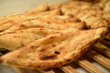 Georgian pita bread on a wooden grate