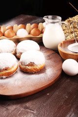 german donuts or berliner with ingredient on rustic background