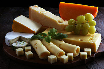 Cheese plate served with grapes, various cheese on a platter