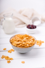 Cornflakes cereal and milk in a glass. Morning tasty breakfast concept