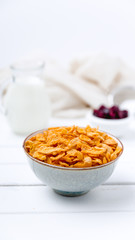 Cornflakes cereal and milk in a glass. Morning tasty breakfast concept