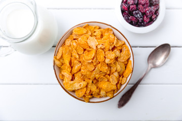 Cornflakes cereal and milk in a glass. Morning tasty breakfast concept