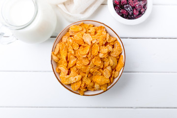 Cornflakes cereal and milk in a glass. Morning tasty breakfast concept