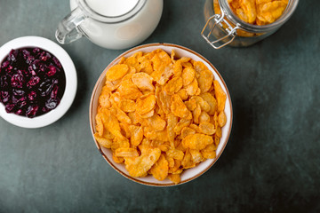 cornflakes cereal and milk in a glass. Morning tasty breakfast concept