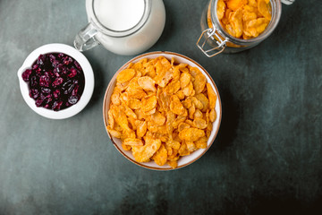cornflakes cereal and milk in a glass. Morning tasty breakfast concept