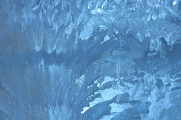 frosty pattern on the window draws winter blue color