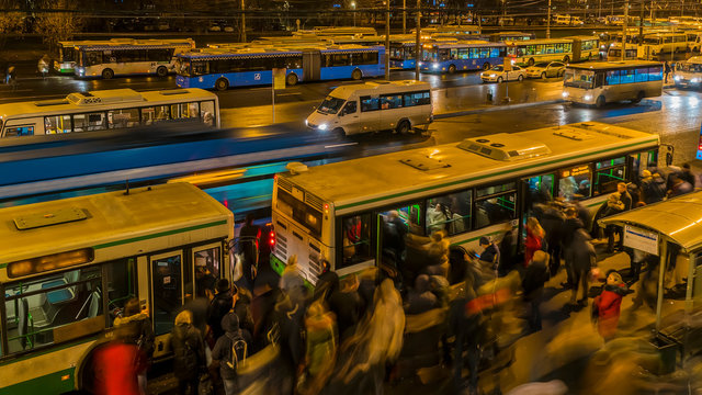 passengers waiting and boarding buses at the bus terminal