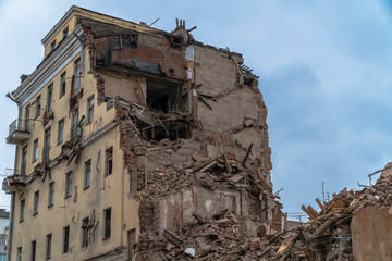 The wreckage and the skeleton of an old building destroyed to make room for modern development