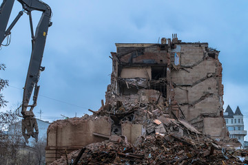 demolition of a multi-storey building with hydraulic shears, for future development of residential buildings