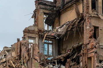 The wreckage and the skeleton of an old building destroyed to make room for modern development
