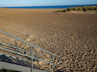 Down to the sand on a beach in Norfolk on a sunny day