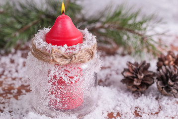 Christmas background with festive decoration, spruce branches, snowflakes, burning red candles