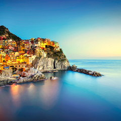 Fototapeta na wymiar Manarola village, rocks and sea. Cinque Terre, Italy. Long Exposure.