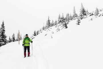 Fototapeta na wymiar Winter hike in white, man and adventure concept