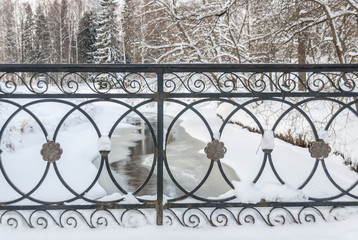 An ancient grille overlooking the winter river