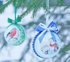 Christmas balls hanging on the Christmas tree branches.