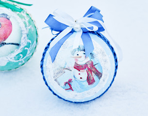 Christmas balls lying on the snow. Cold toning