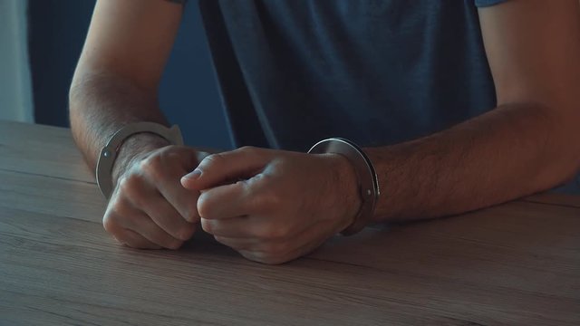 Criminal suspect giving statement in police interrogation room