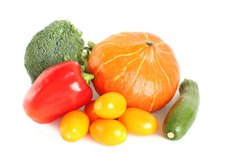 Pumpkin, broccoli, zucchini, red paprika, yellow plum tomatoes and cucumbers on white background