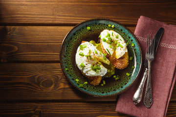 poached eggs on baguette with greens.