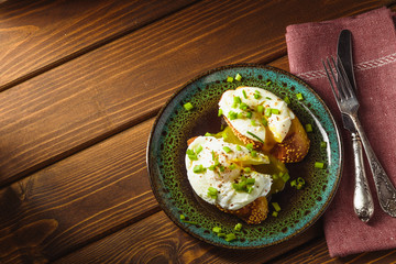 poached eggs on baguette with greens.