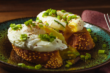 poached eggs on baguette with greens.
