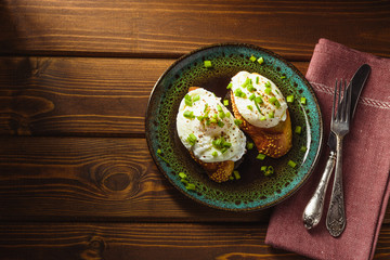 poached eggs on baguette with greens.