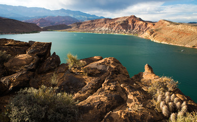 Sunset over lake and desert mountain landscape; Quail Creek Reservoir, Southern Utah