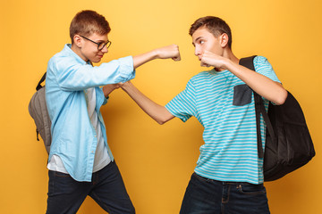 Serious opponents, two teenagers, guys show fists, ready for battle, have strict facial...